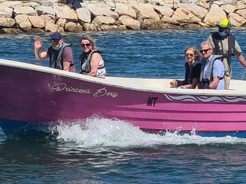 a group of people in a small boat in the water
