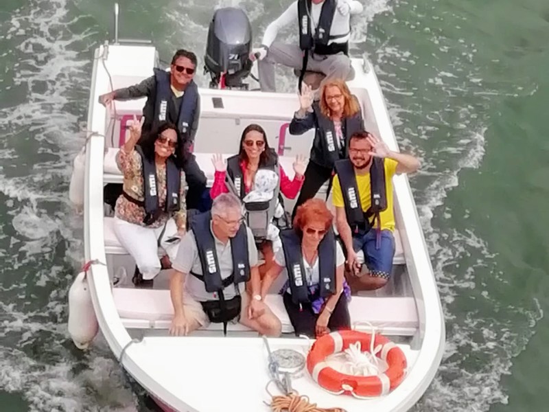 a group of people in a small boat in a body of water