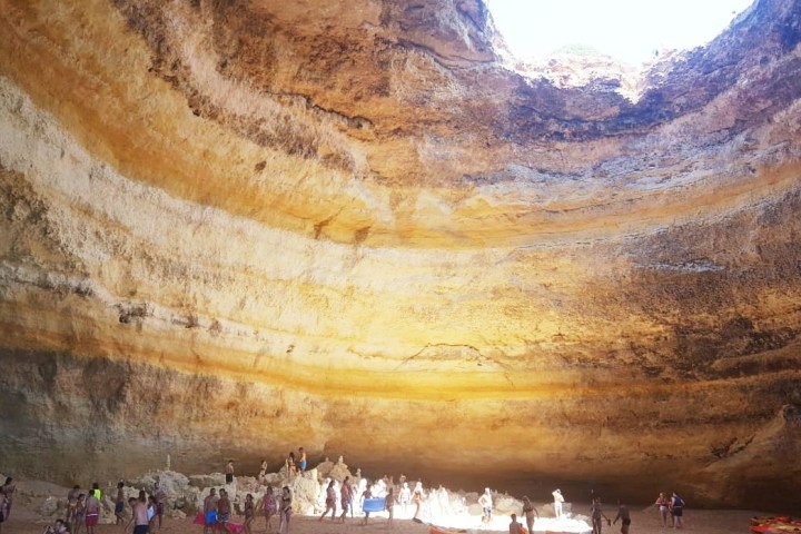 a group of people standing inside the Benagil Sea Cave